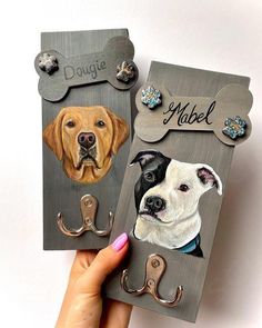 two magnets with dogs on them are being held up