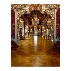 an ornately decorated hall with chandeliers and mirrors