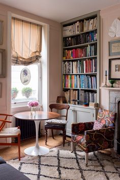 a living room filled with furniture and bookshelves