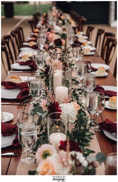 a long table is set with candles and flowers for a formal dinner or wedding reception