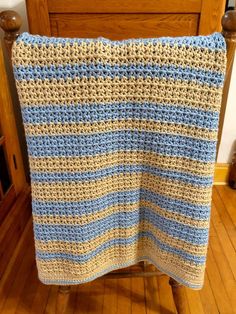 a crocheted blanket sitting on top of a wooden chair