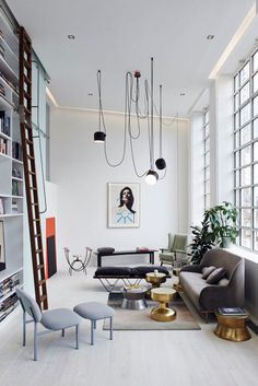 a living room filled with furniture and lots of windows