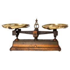 an old scale with two brass plates on it