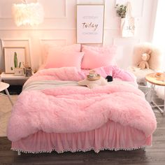 a bedroom with pink bedding and pillows