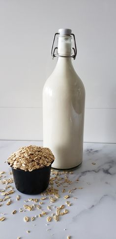 a bottle of milk next to a bowl of oatmeal