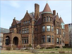 an old brick building with many windows and towers