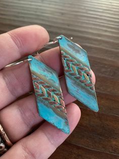 These earrings feature mixed metals of solid, gold brass & raw copper and are finished with a unique turquoise verdigris patina. The patina has been sealed with a good coating of renaissance wax but should not be worn while showering or bathing to maintain patina. The ear wires are forged by hand from 20g Sterling silver. These earrings have a celtic / tribal feel. They are versatile and suitable for just about any style, from modern to rustic. They're substantial but comfortable to wear. Th Artisan Hand Forged Metal Jewelry, Artisan Hand-forged Metal Jewelry, Blue Artisan Copper Earrings, Artisan Blue Copper Earrings, Artisan Nickel-free Rust-colored Jewelry, Artisan Rust Color Nickel-free Jewelry, Artisan Rust-colored Nickel-free Jewelry, Earthy Bronze Dangle Jewelry, Earthy Copper Jewelry For Festivals