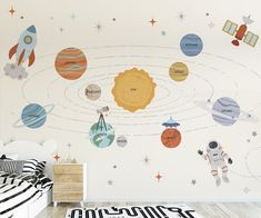 this is an image of a child's bedroom with planets and stars on the wall