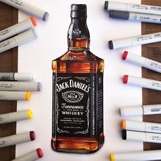 a bottle of jack daniels whiskey surrounded by markers