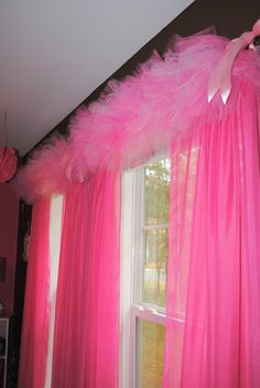 an instagramted photo of a pink curtain with feathers on it and the caption says,