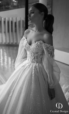 a woman in a ball gown standing on the floor