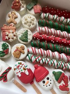 a box filled with lots of different decorated cookies and candy canes on top of each other