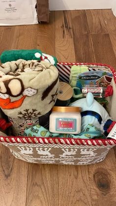 a basket filled with baby items on top of a wooden floor