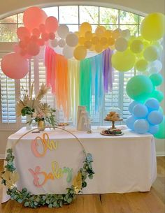 a table with balloons and streamers on it