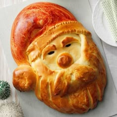 an apple shaped pastry with a face on it's side next to a white plate