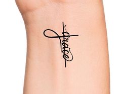 a woman's arm with a tattoo on it that says faith in cursive writing