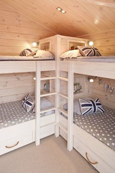 there are two bunk beds with pillows on the bottom and one has a union jack flag pillow