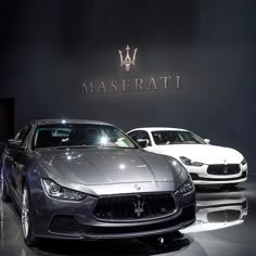 three maserati cars are on display at an auto show