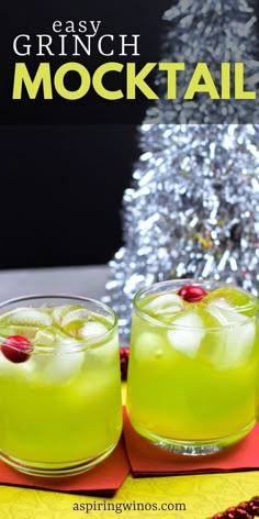 two glasses filled with green cocktail next to a christmas tree