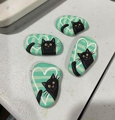 four magnets with black cats on them