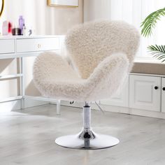 a white chair sitting on top of a hard wood floor next to a dresser and mirror