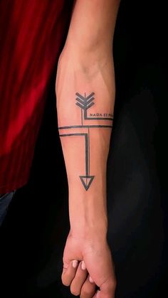 a person with a cross tattoo on their arm