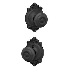 two black knobs with ornate designs on the front and back of each door handle