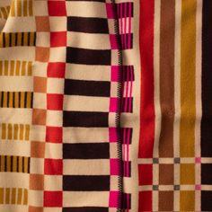 the fabric is multicolored and has different patterns on it, including stripes and lines