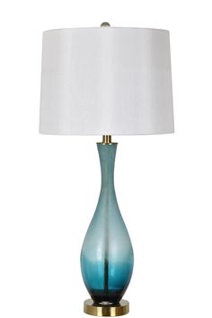 a blue glass table lamp with a white shade