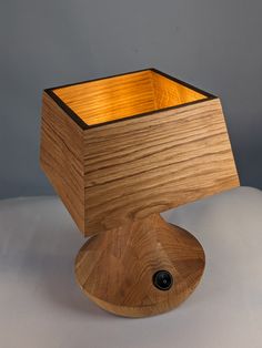 a wooden object sitting on top of a white table