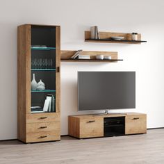 an entertainment center with shelves and a flat screen tv