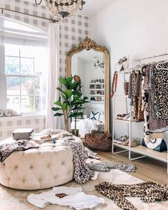 a bedroom with leopard print on the floor and clothes hanging in front of a window