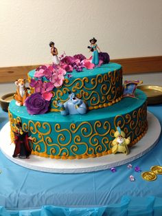 the cake is decorated with figurines and flowers on it's tiers