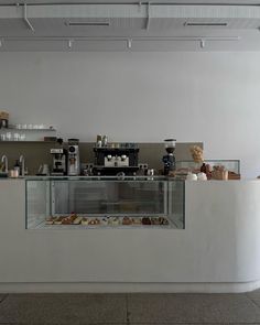 a counter with some food on it in a room that has white walls and ceilings