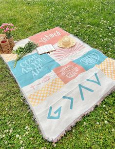 a picnic blanket on the grass with flowers