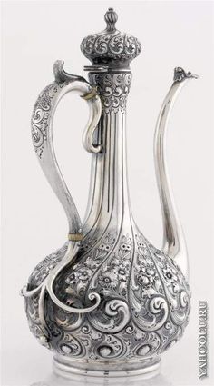 an ornate silver tea pot on a white background