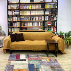 a living room with a couch and bookcases filled with lots of books on it