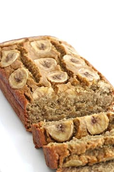 slices of banana bread stacked on top of each other with sliced bananas in the middle