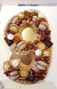 a large number shaped cake with chocolates and nuts