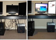 two computer screens sitting on top of a black desk next to each other with wires running all over them