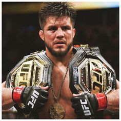 a close up of a person wearing gloves and holding a wrestling ring in their hands