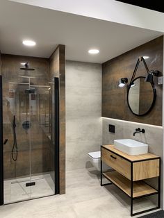 a bathroom with a stand up shower next to a white sink and wooden counter top