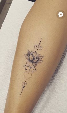 a woman's leg with a lotus tattoo on the lower half of her leg