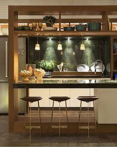 an image of a kitchen island with stools in the center and lights above it