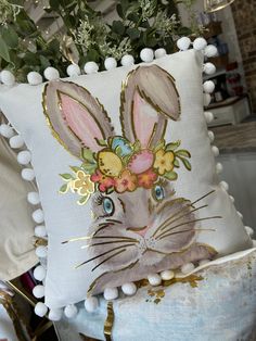 a decorative pillow with an image of a rabbit on it