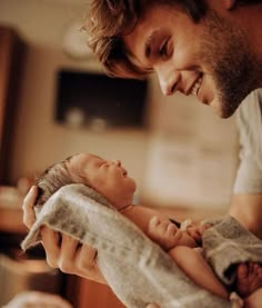 a man holding a baby in his arms