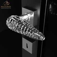 the door handle is made out of metal and has an intricate design on it's side