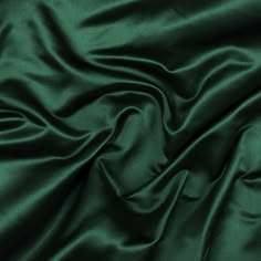 Mood's silk duchesse satin is a beautiful and regal silk fabric. It has a duller sheen then a regular satin on one side, comes in a medium weight, and has a firmer hand. An elegant fabric for special occasion wear. Available in 25+ vivid shades, prom dresses and bridesmaids attire awaits!   Note: Dye lots are subject to change up to 10% in either direction. Ordering swatches is HIGHLY recommended for these products. Stretch Satin Fabric, Raw Silk Fabric, Dark Green Aesthetic, By Any Means Necessary, Slytherin Aesthetic, Aesthetic Green, Lace Evening Dresses, Stretch Satin, Green Satin