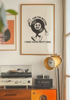 a record player sitting on top of a wooden dresser