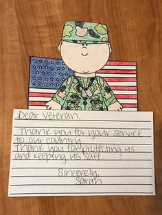 a soldier holding up a sign with writing on it